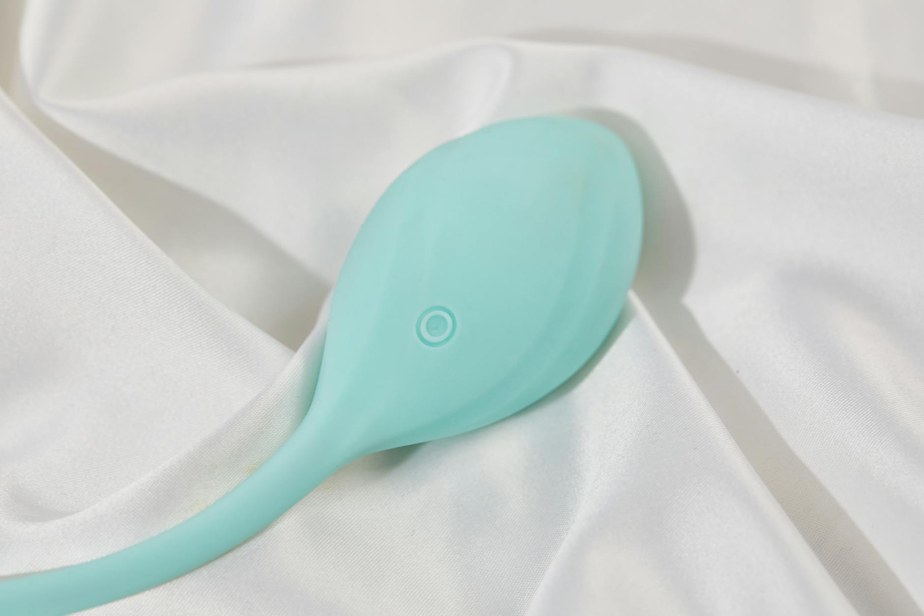 A young couple standing together holding a clitoral vibrator, symbolizing open communication about shared intimacy