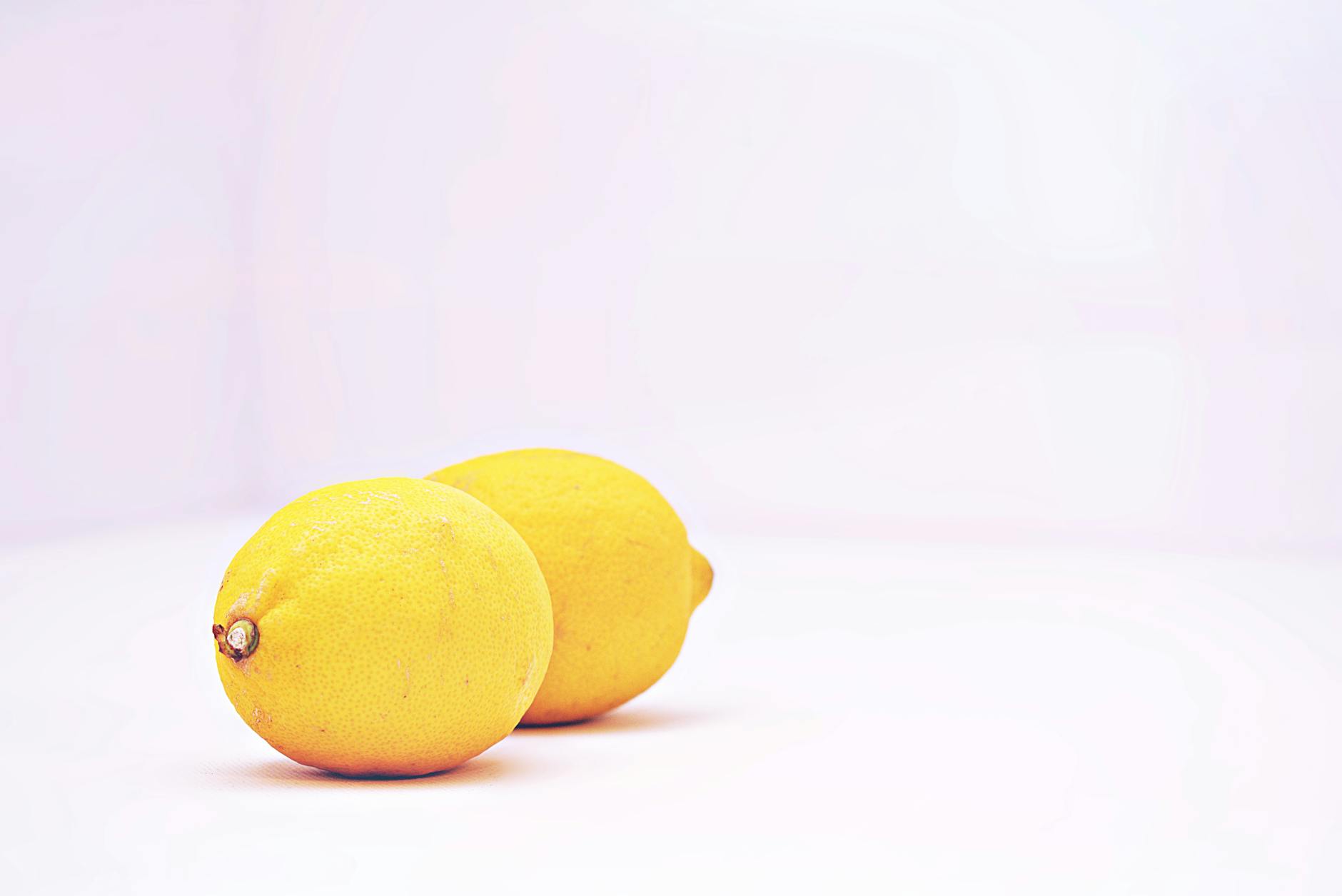 Two lemons on a white background, symbolizing fresh starts and renewal