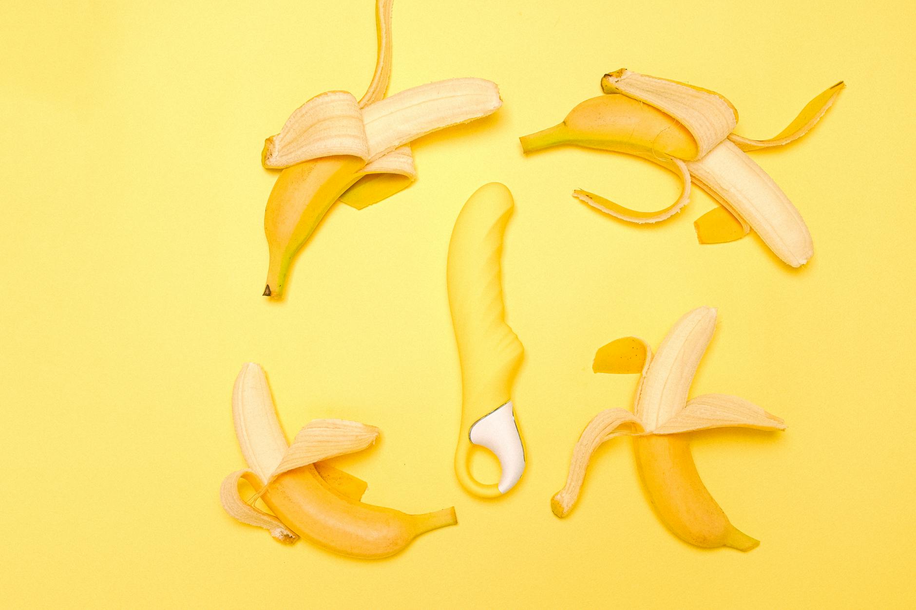 Bright yellow lemon vibrator on a yellow background, symbolizing renewal and reconnection to pleasure.