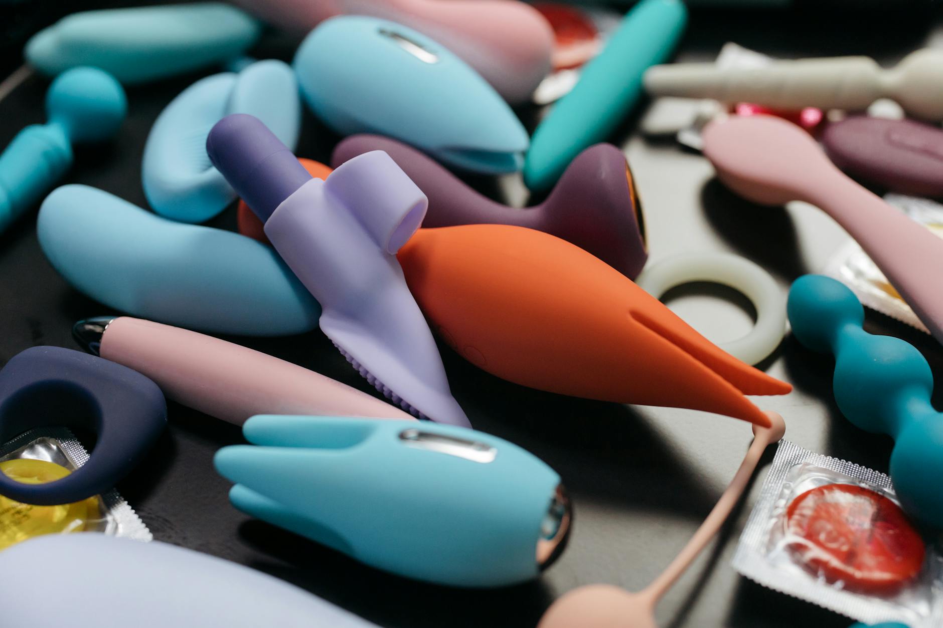 A couple standing together indoors, holding a vibrator, symbolizing modern long distance intimacy