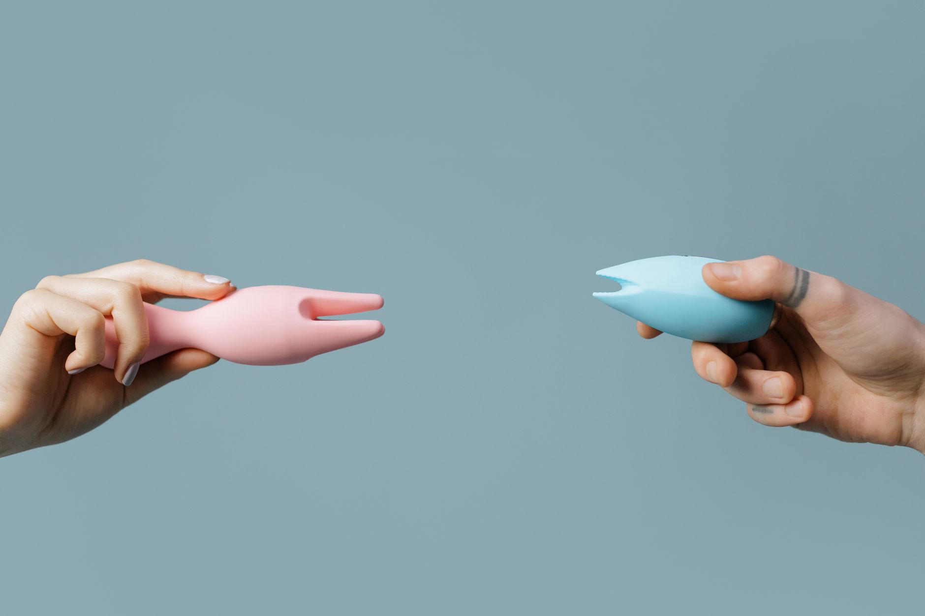 A hand holding a sleek orange vibrator against a minimalist purple backdrop, symbolizing modern recovery and wellness.